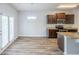 Modern kitchen features stainless appliances, granite countertops, wood cabinets and an island with a sink at 1003 Eldon Ln, Fairburn, GA 30213