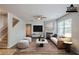 Virtually staged living room with hardwood floors and a fireplace at 1003 Eldon Ln, Fairburn, GA 30213