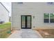 A small patio area featuring a door to the home and a window at 1003 Eldon Ln, Fairburn, GA 30213
