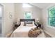 Bedroom with hardwood floors, neutral walls, modern lighting, windows, and queen bed at 2294 Hill Nw St, Atlanta, GA 30318
