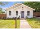 Charming home featuring a manicured lawn, attractive gray front door, and a welcoming facade at 2294 Hill Nw St, Atlanta, GA 30318