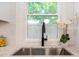 Close-up of the kitchen sink with a black faucet with view to backyard at 2294 Hill Nw St, Atlanta, GA 30318