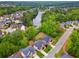 Aerial view of neighborhood homes surrounding a beautiful lake with lush green landscape at 280 Lakestone Pkwy, Woodstock, GA 30188