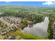 Community aerial view featuring a lake, playground, and surrounding homes with lush, green trees at 280 Lakestone Pkwy, Woodstock, GA 30188