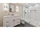 Bathroom featuring a modern vanity, stylish mirror, sleek lighting, and a tiled walk-in shower at 280 Lakestone Pkwy, Woodstock, GA 30188