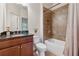 Well-lit bathroom with granite countertop vanity and shower over tub with decorative brown tiles at 280 Lakestone Pkwy, Woodstock, GA 30188