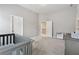 Carpeted bedroom featuring a crib and a dresser at 280 Lakestone Pkwy, Woodstock, GA 30188