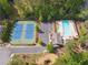 Aerial view of community pool and tennis court with playground, pool and lush landscaping at 280 Lakestone Pkwy, Woodstock, GA 30188