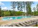 Community pool with multiple lounge chairs for residents to enjoy poolside relaxation at 280 Lakestone Pkwy, Woodstock, GA 30188