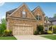 A well-maintained brick home with a two-car garage and manicured landscaping at 280 Lakestone Pkwy, Woodstock, GA 30188