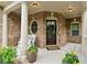 Welcoming front porch with brick accents, a charming bench, and a stylish front door at 280 Lakestone Pkwy, Woodstock, GA 30188
