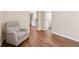 Hallway with hardwood floors, chair, and bathroom access at 280 Lakestone Pkwy, Woodstock, GA 30188