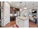Open-concept kitchen featuring granite countertops, stainless appliances, and center island seating at 280 Lakestone Pkwy, Woodstock, GA 30188
