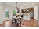 Eat-in kitchen features dark wood cabinets, stainless steel appliances, and granite countertops at 280 Lakestone Pkwy, Woodstock, GA 30188