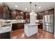 Gourmet kitchen with granite counters, stainless appliances and rich dark wood cabinets at 280 Lakestone Pkwy, Woodstock, GA 30188
