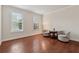 Cozy living room featuring hardwood floors, neutral walls, and an abundance of natural light at 280 Lakestone Pkwy, Woodstock, GA 30188