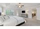 Bright main bedroom features tray ceilings, neutral carpet, and windows overlooking trees at 280 Lakestone Pkwy, Woodstock, GA 30188