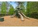 Community playground featuring slides and climbing structures, all surrounded by a soft landing area at 280 Lakestone Pkwy, Woodstock, GA 30188