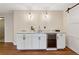 Wet bar with white cabinetry, granite countertops, wine fridge, and a sink at 280 Lakestone Pkwy, Woodstock, GA 30188