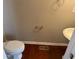 A half bathroom with hardwood floors, classic pedestal sink, and toilet at 308 Holbrook Rd # Bldg 11, Smyrna, GA 30082