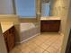 Tile floor bathroom featuring a tub and a vanity with cherry wood cabinets at 308 Holbrook Rd # Bldg 11, Smyrna, GA 30082
