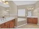 Bright bathroom with large tub, double sinks, neutral tile, and cherry wood cabinets at 308 Holbrook Rd # Bldg 11, Smyrna, GA 30082