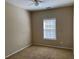 Cozy bedroom with plush carpet, ceiling fan, and a window providing natural light at 308 Holbrook Rd # Bldg 11, Smyrna, GA 30082