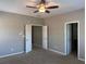 Neutral bedroom with ceiling fan, carpet floors, two white doors, and open door to a bathroom at 308 Holbrook Rd # Bldg 11, Smyrna, GA 30082