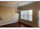Bright dining area with hardwood floors, a modern chandelier, and a view through large windows at 308 Holbrook Rd # Bldg 11, Smyrna, GA 30082