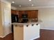 Kitchen featuring wooden cabinets, stainless steel appliances, and breakfast bar overlooking the living area at 308 Holbrook Rd # Bldg 11, Smyrna, GA 30082