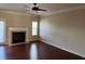 Spacious living room with fireplace, modern ceiling fan, and plenty of natural light from two windows at 308 Holbrook Rd # Bldg 11, Smyrna, GA 30082