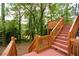 Wooden deck with multiple levels surrounded by lush green trees and foliage creating a relaxing outdoor space at 4328 Alison Jane Ne Dr, Kennesaw, GA 30144