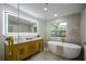 Modern bathroom featuring a double vanity, freestanding tub, and sleek lighting at 4328 Alison Jane Ne Dr, Kennesaw, GA 30144