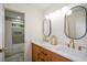 Modern bathroom featuring double sinks, marble countertops, and a shower in the background at 4328 Alison Jane Ne Dr, Kennesaw, GA 30144