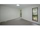 Bright bedroom with new carpet, neutral walls, and a view of the trees at 4328 Alison Jane Ne Dr, Kennesaw, GA 30144