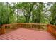 Wooden deck overlooking a lush, wooded backyard, perfect for outdoor entertaining at 4328 Alison Jane Ne Dr, Kennesaw, GA 30144