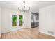 Dining area with light floors, chandelier, access to deck, open to updated kitchen at 450 High Creek Trce, Roswell, GA 30076