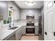 Updated kitchen featuring stainless steel appliances, gray cabinets, and modern fixtures at 450 High Creek Trce, Roswell, GA 30076