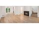 Spacious living room with fireplace, stairs and access to outdoor deck at 450 High Creek Trce, Roswell, GA 30076