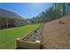 View of the lawn and backyard with a garden bed at 516 Barnwood Dr, Rockmart, GA 30153