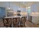 Modern kitchen with white cabinetry, stainless steel appliances, granite countertops and barstool seating at 516 Barnwood Dr, Rockmart, GA 30153