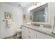 A well-lit bathroom featuring a vanity with a framed mirror and a glass door shower at 1015 Bedford Gardens Dr, Alpharetta, GA 30022