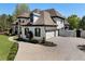 Beautiful home featuring a circular driveway, three-car garage, and manicured lawn at 1015 Bedford Gardens Dr, Alpharetta, GA 30022