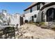 Beautiful home exterior with stone patio area perfect for outdoor dining and entertainment at 1015 Bedford Gardens Dr, Alpharetta, GA 30022