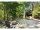 Enjoy outdoor gatherings with a stone firepit and comfortable seating nestled amongst mature trees at 1015 Bedford Gardens Dr, Alpharetta, GA 30022
