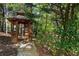 Charming gazebo surrounded by trees and colorful azaleas, creating a serene retreat in nature at 1015 Bedford Gardens Dr, Alpharetta, GA 30022