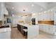 A gourmet kitchen with stainless appliances, an island with seating, and modern lighting at 1015 Bedford Gardens Dr, Alpharetta, GA 30022