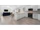 Open-concept kitchen with white cabinets, granite countertops, stainless steel appliances, and an island at 1015 Bedford Gardens Dr, Alpharetta, GA 30022