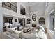 Bright, elegant living room with fireplace, large windows, and comfortable seating at 1015 Bedford Gardens Dr, Alpharetta, GA 30022