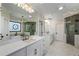 A luxurious bathroom with a large vanity, soaking tub, and glass enclosed shower at 1015 Bedford Gardens Dr, Alpharetta, GA 30022